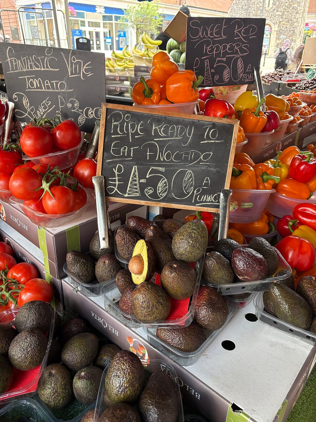Handwritten chalkboard prices on a fruit and vegetable stall in Canterbury